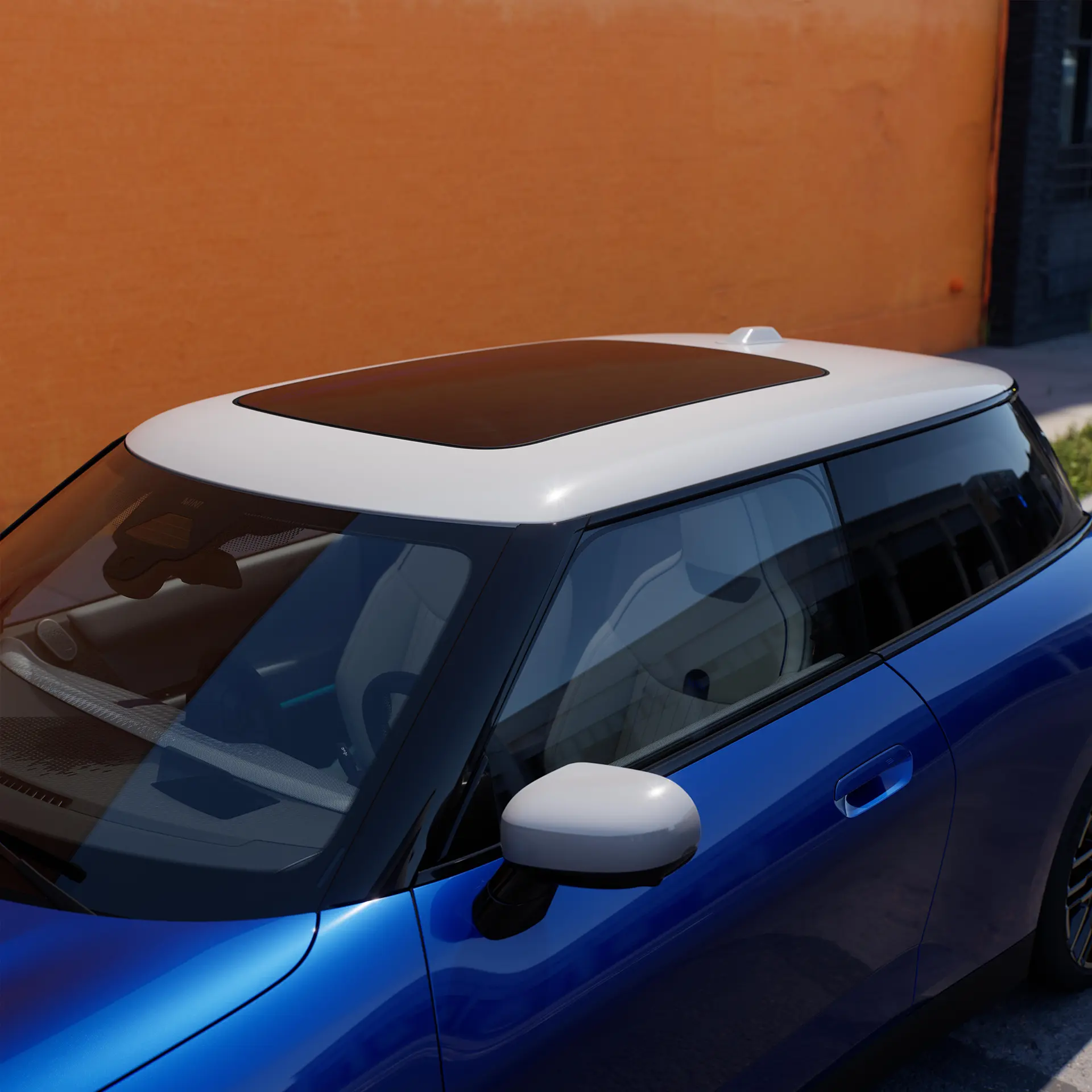 Bild ovanifrån på helt elektriska MINI Cooper i blått med tak i kontrastfärg och stort glastak.
