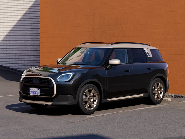 Vy framifrån av en MINI Countryman i Midnight Black och tak i Vibrant Silver som parkerar.